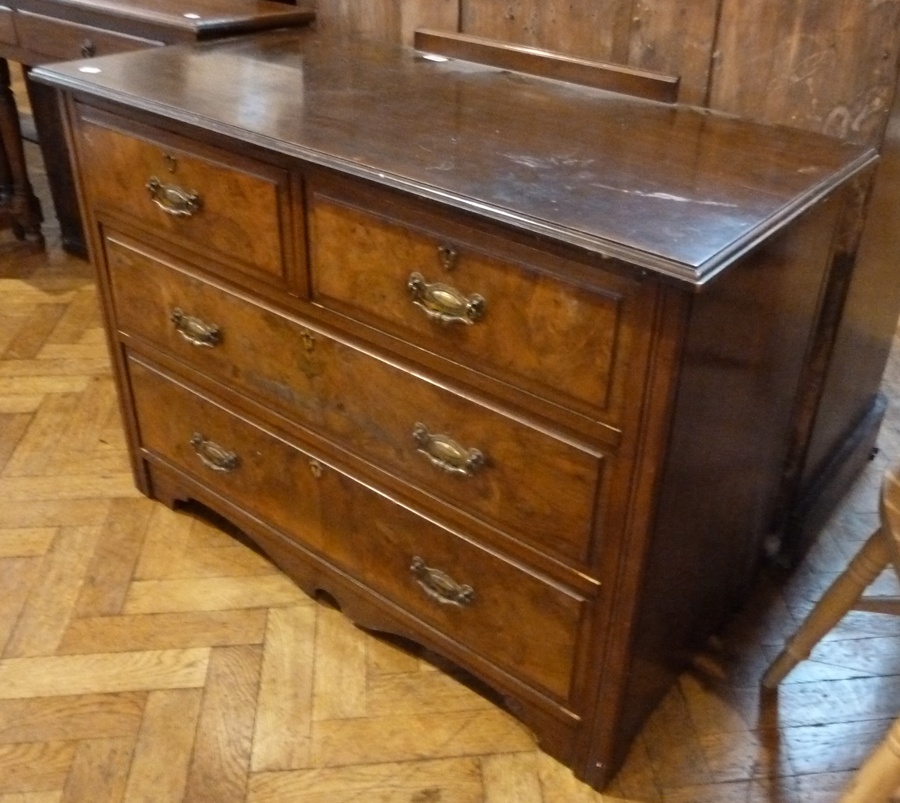 A twentieth century walnut chest of two short and two long drawers, with brass handles and back