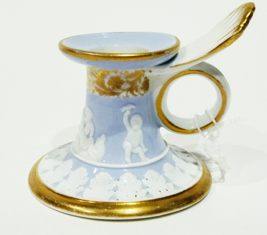 Early 19th century Spode chamberstick, with circular base, decorated with white raised cupids