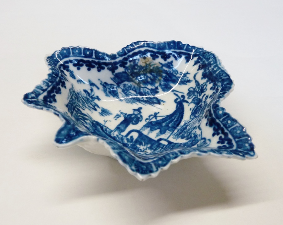 An eighteenth-century porcelain pickle dish, possibly Caughley, in the form of a leaf, painted in