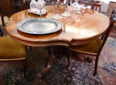 Victorian rosewood veneered loo table, the shaped top raised on carved and turned pedestal and