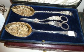 Cased set of late Victorian berry spoons, EPNS, and grape scissors, the bowls of the spoons with