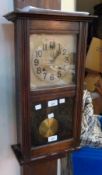 Twentieth century stained wood wall clock, with glazed door with channelled case, ogee mould lower