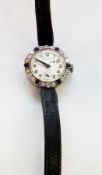 Lady's Swiss platinum, diamond and black onyx cocktail wristwatch, circular dial with Arabic