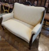 Edwardian mahogany and cream damask two seater settee with square back, having foliate carved