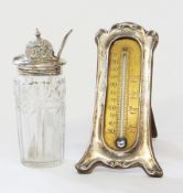 Silver cased table thermometer, Art Nouveau style, on trestle support, and a silver cut glass pickle