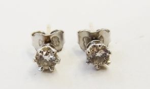 Pair white metal and diamond stud earrings, each stone claw set