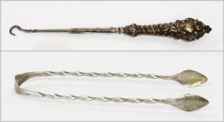 An Edwardian silver-handled buttonhook, Birmingham 1900, maker "E.S.B.", and a silver twisted pair