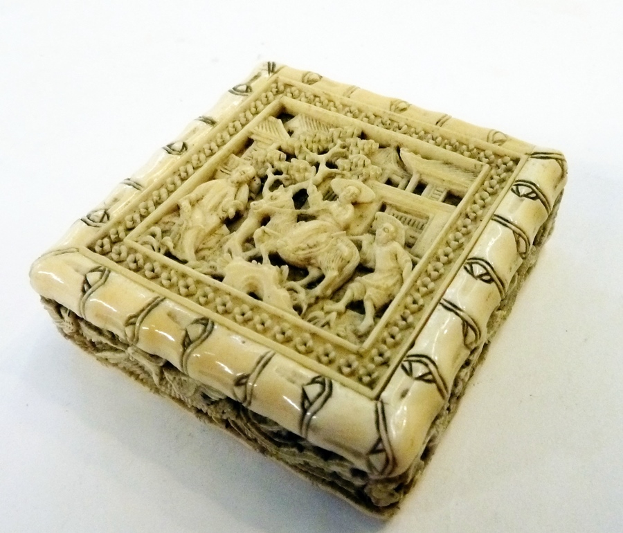 Chinese carved ivory puzzle, square form, with slide-out door to reveal assorted shapes, with relief