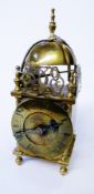 Twentieth century brass lantern-style clock, with engraved and pierced fish pediment, French