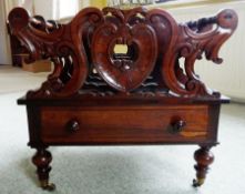 Victorian rosewood Canterbury, scroll carved with drawer below on turned supports and casters,