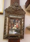 A Venetian wall mirror, with foliate copper mounts, inset rectangular bevelled mirror surrounded