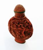 Oriental carved red snuff bottle, domed flowerhead stopper to pagodas and figures in landscape to