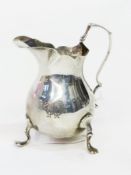 Edwardian milk jug with scalloped edge, scroll handle, baluster body on trefoil feet, Birmingham