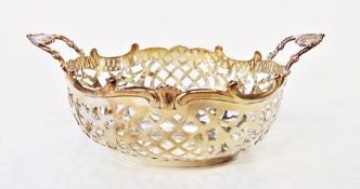 Dutch silver-coloured metal bon-bon basket, oval, two-handled and trelliswork pierced, 15cm wide