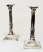 Pair Edwardian Corinthian column candlesticks, with fluted column to beaded and square stepped base,