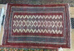 WITHDRAWN
Persian wool rug, red ground, green and cream borders with geometric central lozenge,