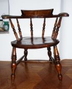 Nineteenth century elm and beech smokers bow open armchair with baluster spindles and supports