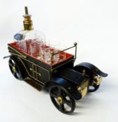 Glass whisky decanter and six glasses in whisky trolley in the form of a vintage car