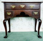 Eighteenth century oak lowboy with cross banded top, three drawers on four cabriole supports pointed