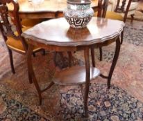 Edwardian mahogany two tiered occasional table, of oval form, on tapering supports