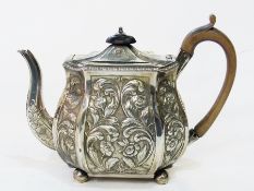 A Georgian teapot, with wooden finial and handle to relief floral  decorated body, bulbous form,