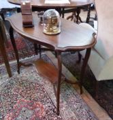 Edwardian mahogany two-tier occasional table, with shaped and moulded top and under-tier