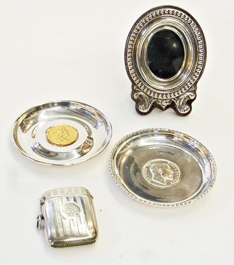 George V silver vesta case, engine-turned, small silver oval easel photograph frame and two EPNS pin