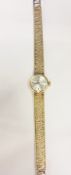 A lady's 9ct gold Omega wristwatch, with circular brush metal dial, baton numerals, side button