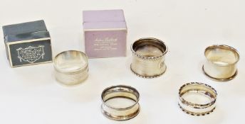 Five assorted silver napkin rings, two in fitted case, assorted decorations, marks and dates (1