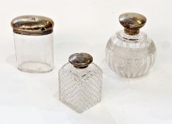 Early twentieth century silver topped glass jars, to include a circular scent bottle (marks worn),