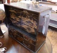 Oriental black lacquered table cabinet, with gilt scenes of pagodas in a mountainous landscape,