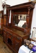 An Edwardian walnut mirrorback sideboard, fret moulded cornice to canopy over carved frieze,