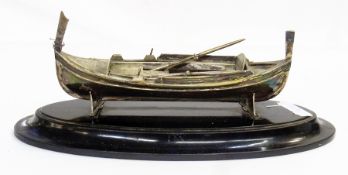 EPNS model rowing boat of gondola form and oars, 22cm wide on  ebonised wooden stand