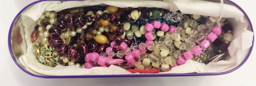 Quantity of assorted vintage necklaces, brooches within a Cadburys tin