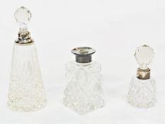 Three various silver topped cut glass toilet bottles