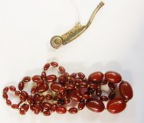 String of graduated dark red amber beads