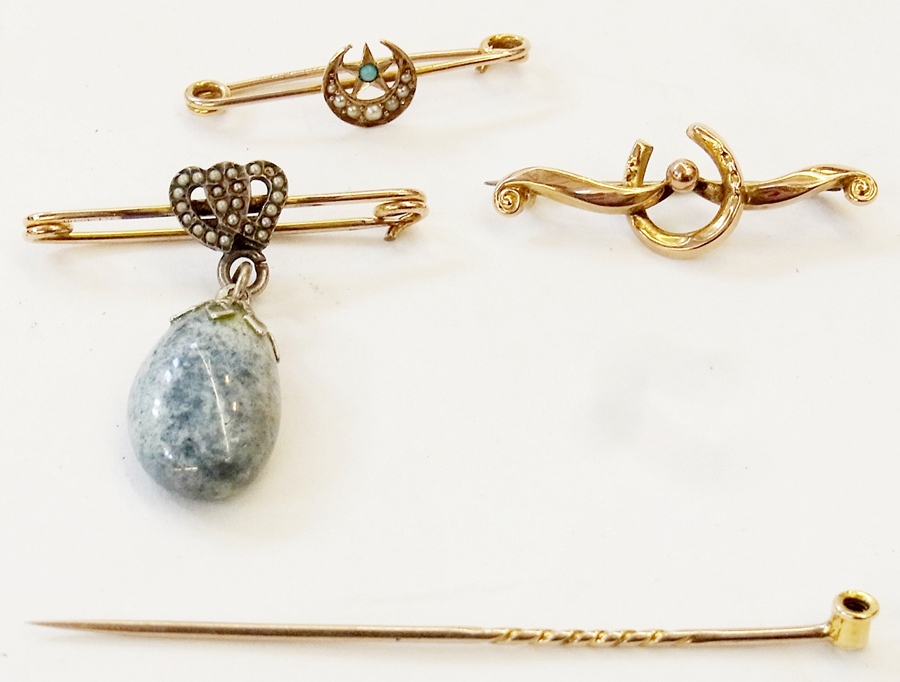 Three gold and gold-coloured metal bar brooches and a stickpin