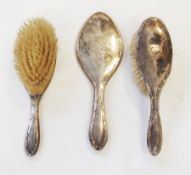 Silver mounted hand mirror with reed and ribband border and a pair matching hairbrushes, in case