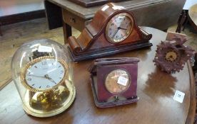 A mahogany effect mantel clock, a gold coloured mantel clock, a miniature Swiss style Cuckoo clock