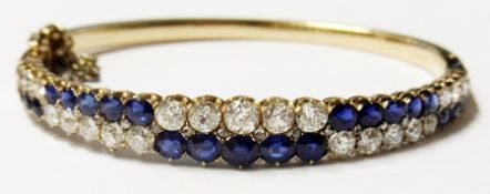 Gold diamond and sapphire bangle set two rows of old cut sapphire and diamonds each in alternating
