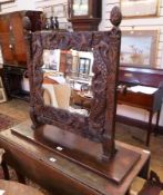 Victorian carved oak square framed swing mirror, heavily decorated with acorn finals, and sea