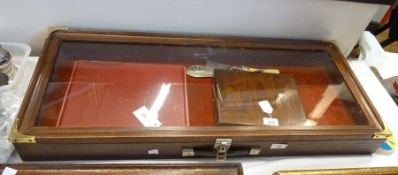 Three wooden display cabinets of various sizes