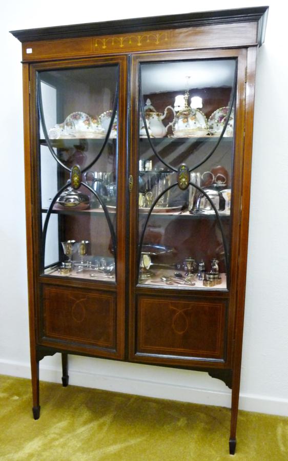 An Edwardian inlaid mahogany china display cabinet, the bar glazed doors having painted roundels, on