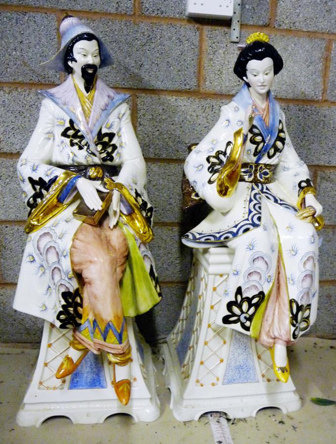 Pair modern Chinese figures, in traditional dress, seated on pedestals, 110cm high