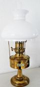 Old brass oil lamp, having white opaque shade