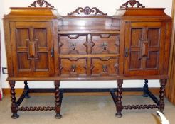 A circa 1920 oak well type caddy top sideboard, the cupboards and drawers having geometric moulded