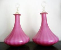 Pair pink glass decanters, with clear glass ring stoppers