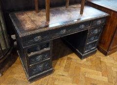 Antique oak revived Renaissance style pedestal desk, heavily carved, with inset leather writing top,