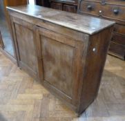 Antique mahogany side cupboard with doors enclosing twelve short drawers and cupboard space with