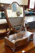 Mahogany serpentine fronted swing toilet mirror, with shield-shaped mirror, three drawers, on